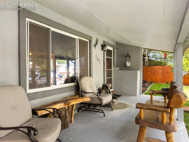 a living room with furniture a flat screen tv and a large window