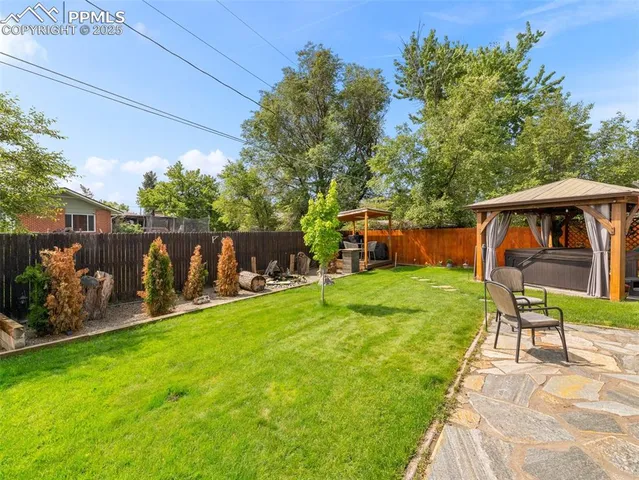 a view of backyard of house with seating space