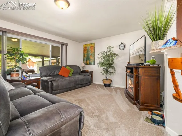 a living room with furniture lamp and a large window