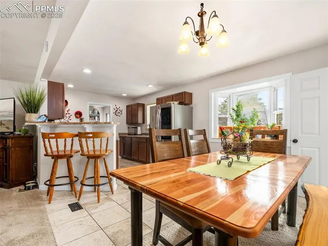 a view of a dining room with furniture window and outside view