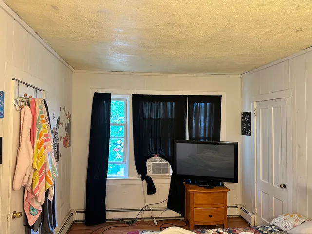 a view of an empty room with wooden floor