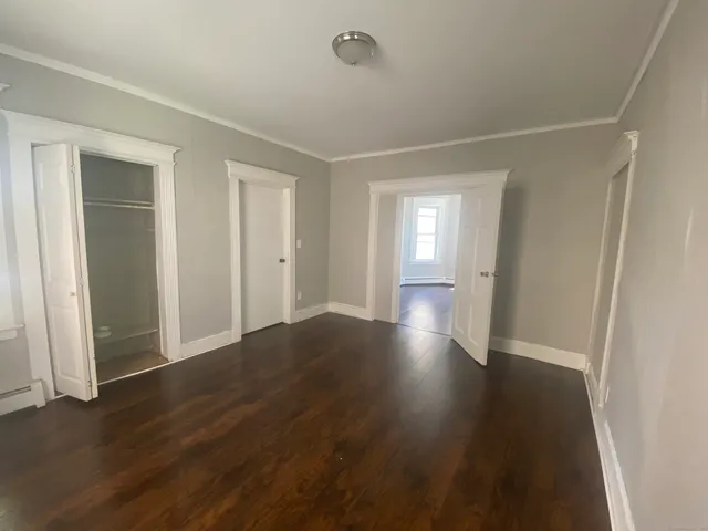 a bedroom with a bed and a tv