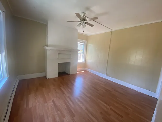 wooden floor in an empty room with a window