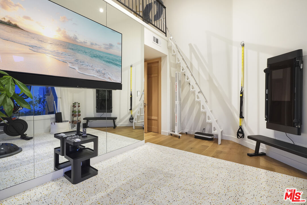3140 Sweetwater Mesa Road Malibu, CA 90265 - Photo 54 of 71 a living room with patio furniture and a flat screen tv