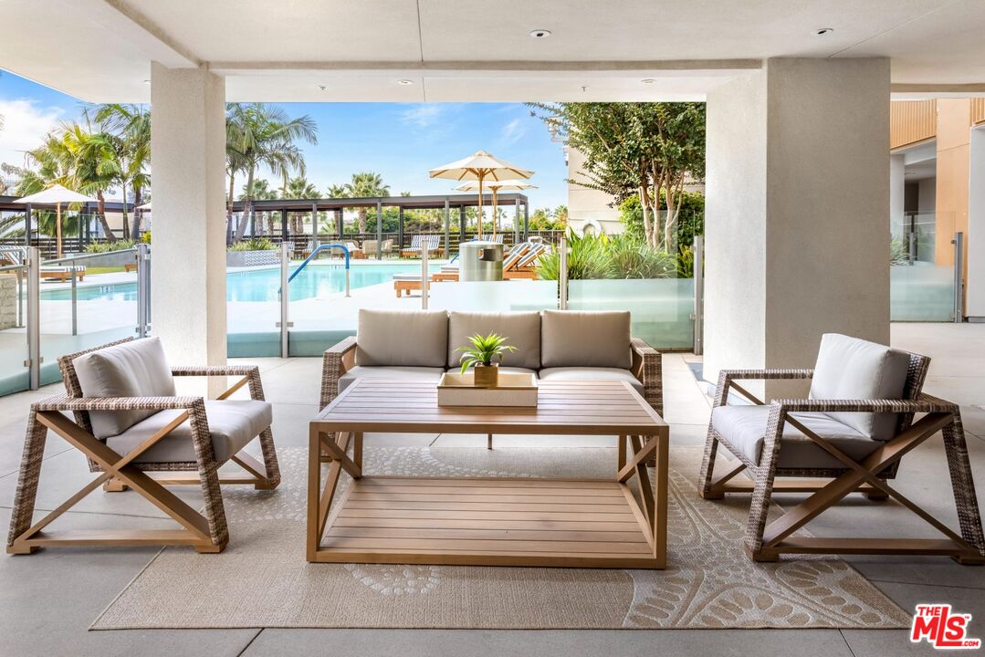 12760 Millennium Drive, Unit NA209 Los Angeles, CA 90094 - Photo 24 of 39 a living room with furniture and a floor to ceiling window