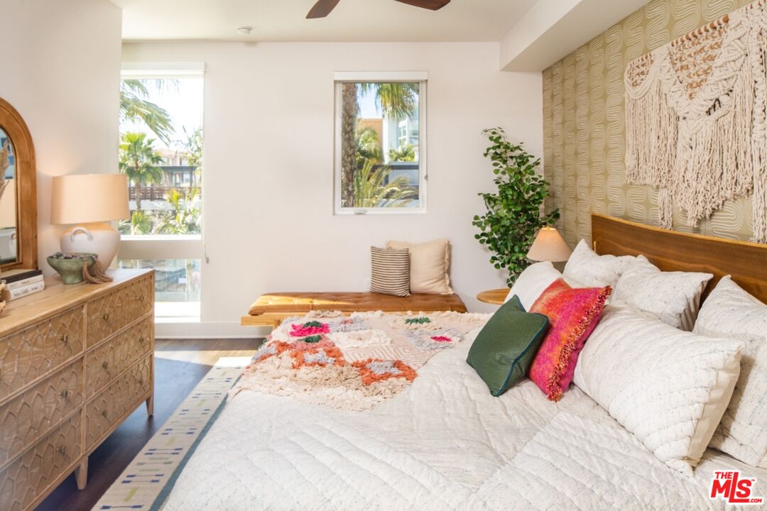 12760 Millennium Drive, Unit NA209 Los Angeles, CA 90094 - Photo 10 of 39 a bedroom with a bed and a potted plant