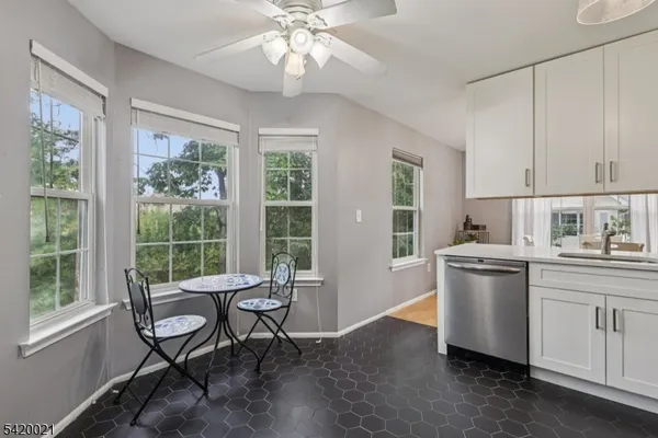 a kitchen with a table chairs and a window