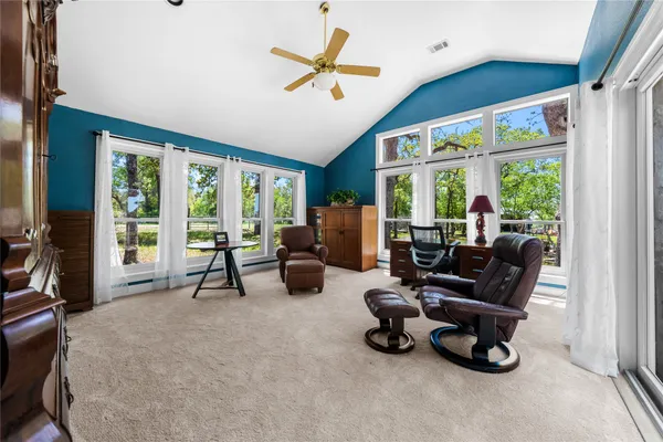 a living room with a bed and a chandelier