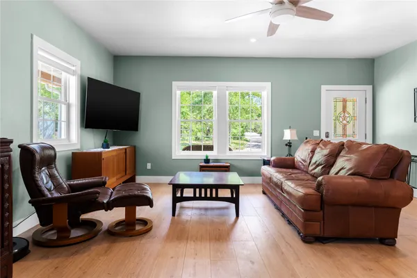 a view of a dining room with furniture and a potted plant