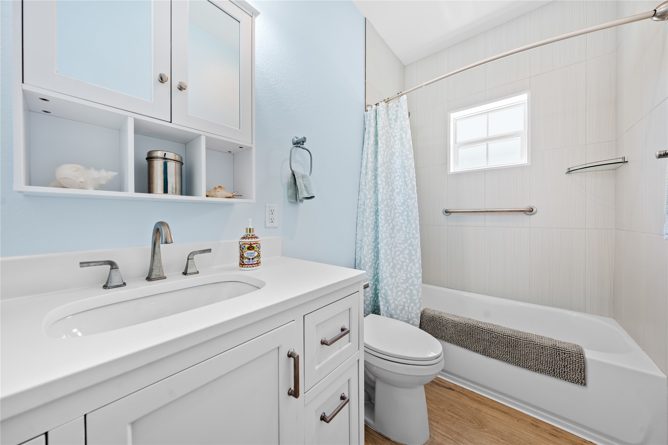 7670 Nez Perce Trace Manor, TX 78653 - Photo 29 of 40 Bathroom featuring toilet, shower / bath combo, wood finished floors, and vanity