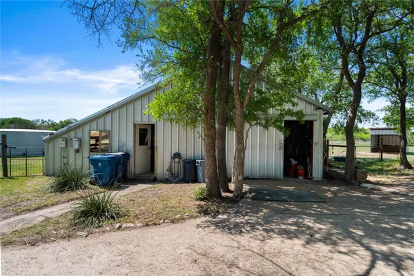 an aerial view of a house with a yard and lake view
