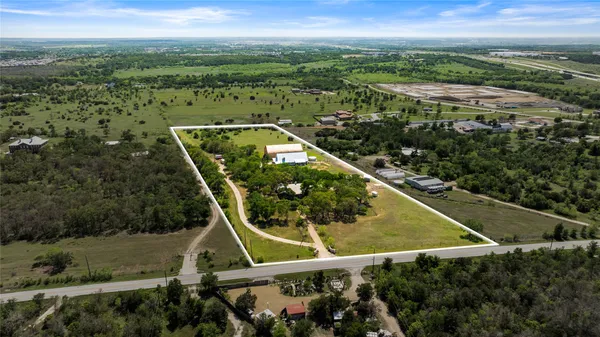 an aerial view of houses with a swimming pool