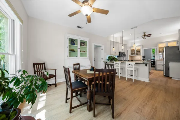 a view of a dining room with furniture and chandelier