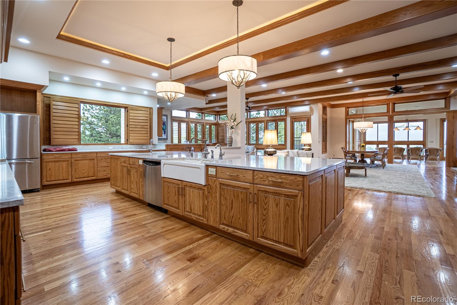 3282 Tomah Road Larkspur, CO 80118 - Photo 18 of 35 a large kitchen with lots of counter space wooden floor and stainless steel appliances
