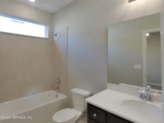 a bathroom with a sink toilet and bathtub