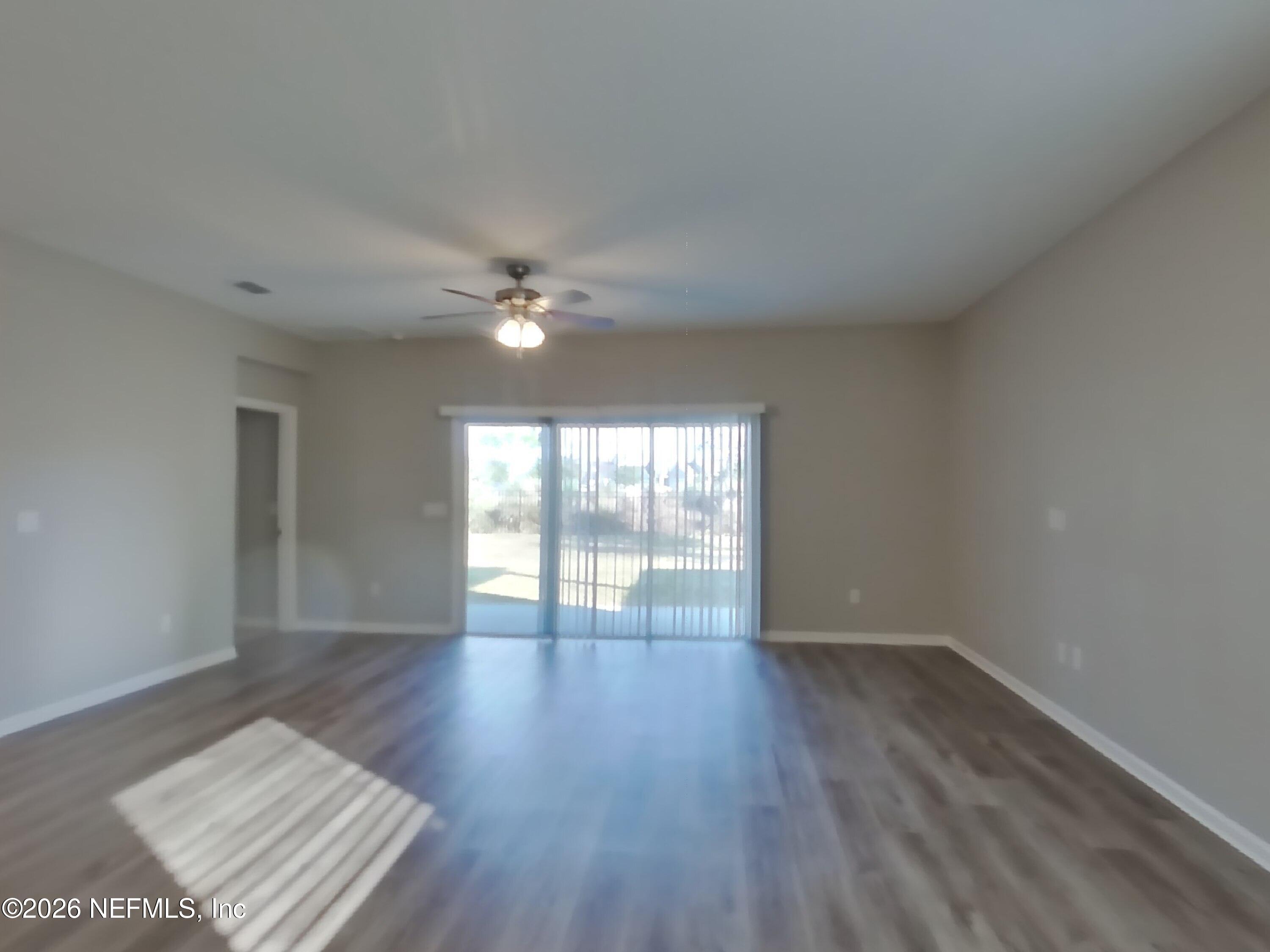155 Bloomfield Way St. Augustine, FL 32092 - Photo 2 of 15 a view of an empty room with wooden floor and a window