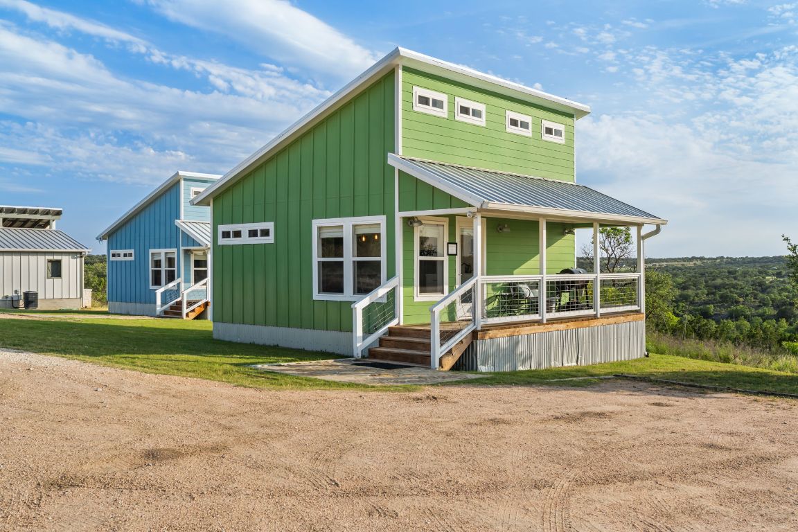 a view of a house with a yard and sitting area