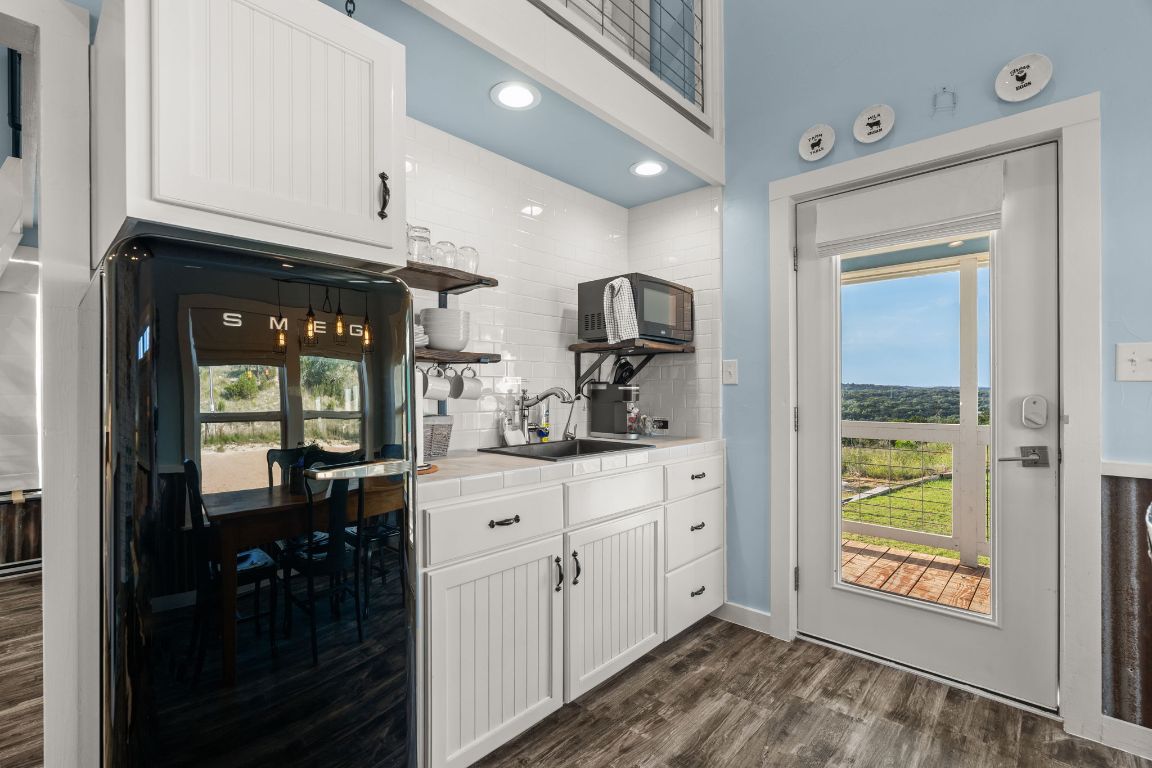 365 Billy Sisson Road Johnson City, TX 78636 - Photo 11 of 40 a kitchen with stainless steel appliances granite countertop a refrigerator and a sink