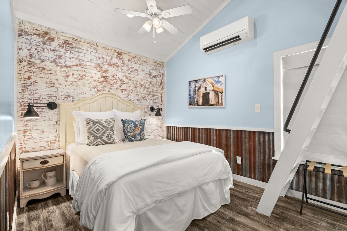 365 Billy Sisson Road Johnson City, TX 78636 - Photo 17 of 40 a bedroom with a bed and a chandelier