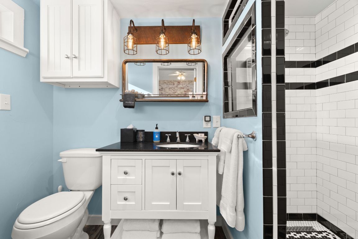 365 Billy Sisson Road Johnson City, TX 78636 - Photo 19 of 40 a bathroom with a toilet a sink and a mirror