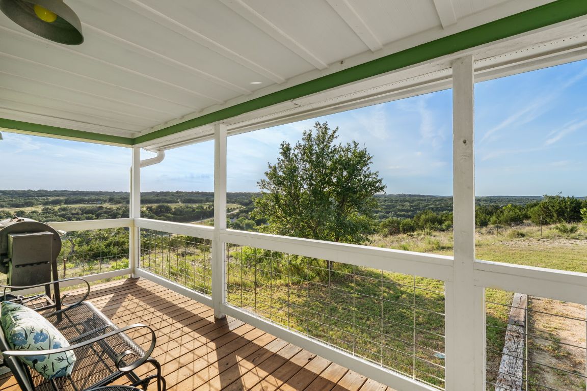 365 Billy Sisson Road Johnson City, TX 78636 - Photo 24 of 40 a view of balcony with floor to ceiling windows with wooden floor