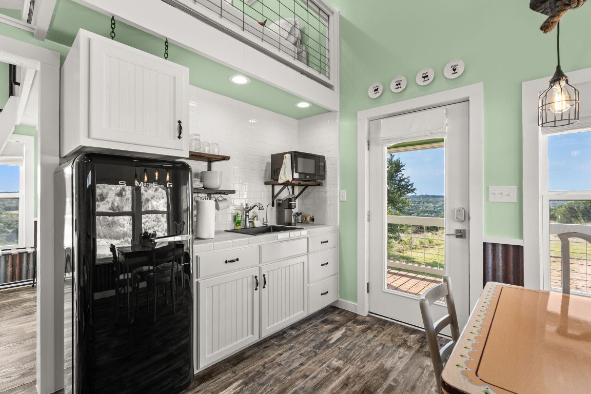 365 Billy Sisson Road Johnson City, TX 78636 - Photo 26 of 40 a kitchen with granite countertop a refrigerator stove top oven and sink