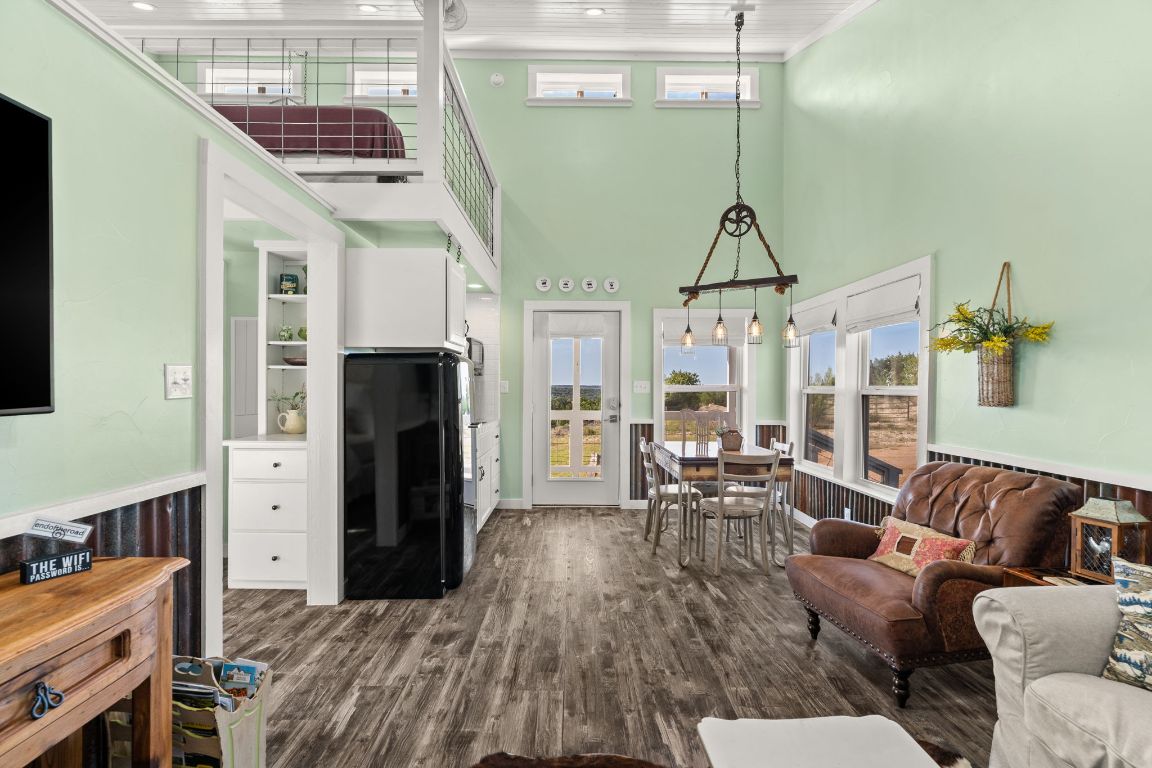 365 Billy Sisson Road Johnson City, TX 78636 - Photo 28 of 40 a living room with furniture a fireplace and a chandelier