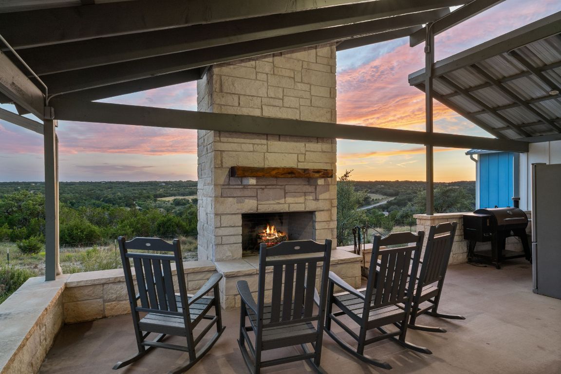 365 Billy Sisson Road Johnson City, TX 78636 - Photo 4 of 40 a view of a porch with chairs and couches with wooden floor