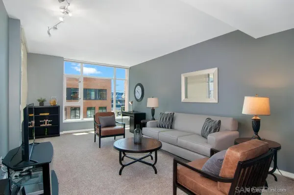 a living room with furniture and a lamp