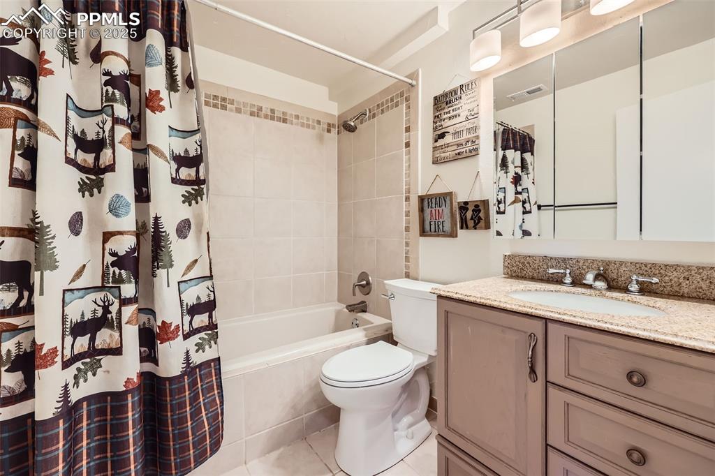 151 Star View Circle Palmer Lake, CO 80133 - Photo 24 of 36 Full bathroom with toilet, vanity, tile patterned floors, and shower / tub combo with curtain