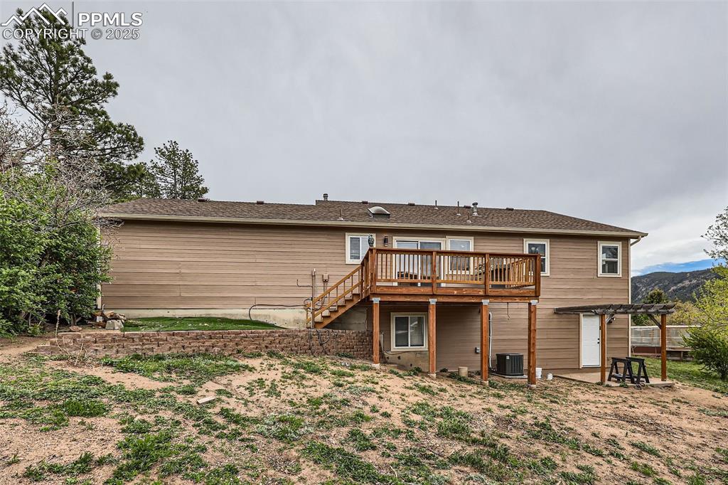 151 Star View Circle Palmer Lake, CO 80133 - Photo 30 of 36 Rear view of house with central AC unit, a deck, a pergola, and stairs