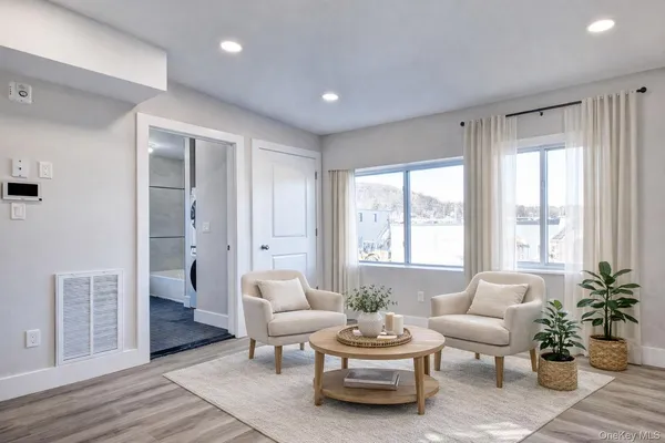 a living room with furniture and a large window