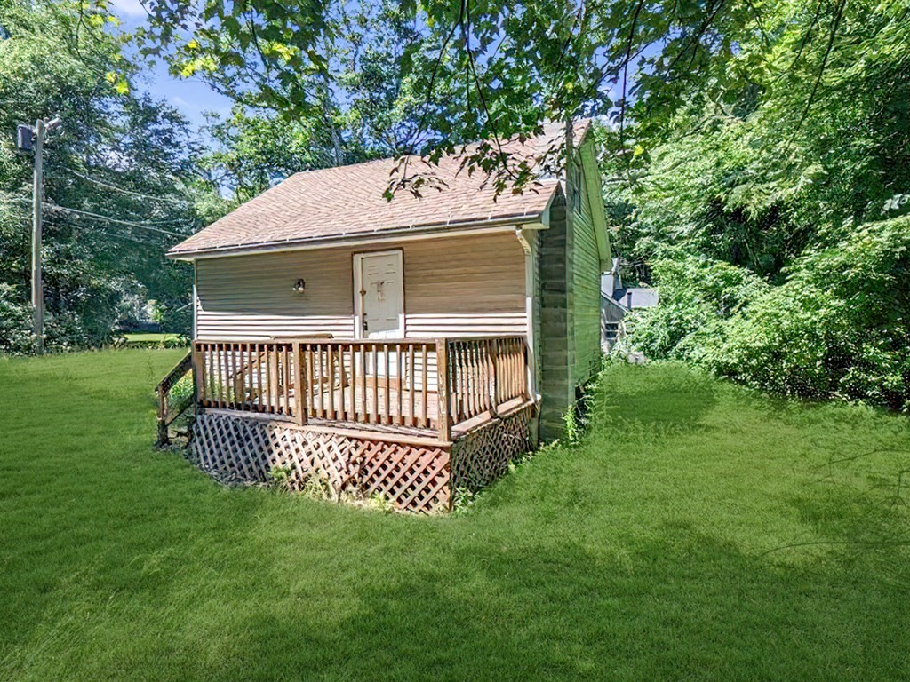36 Pine Road Charlton, MA 01507 - Photo 4 of 9 a view of a house with a yard and deck
