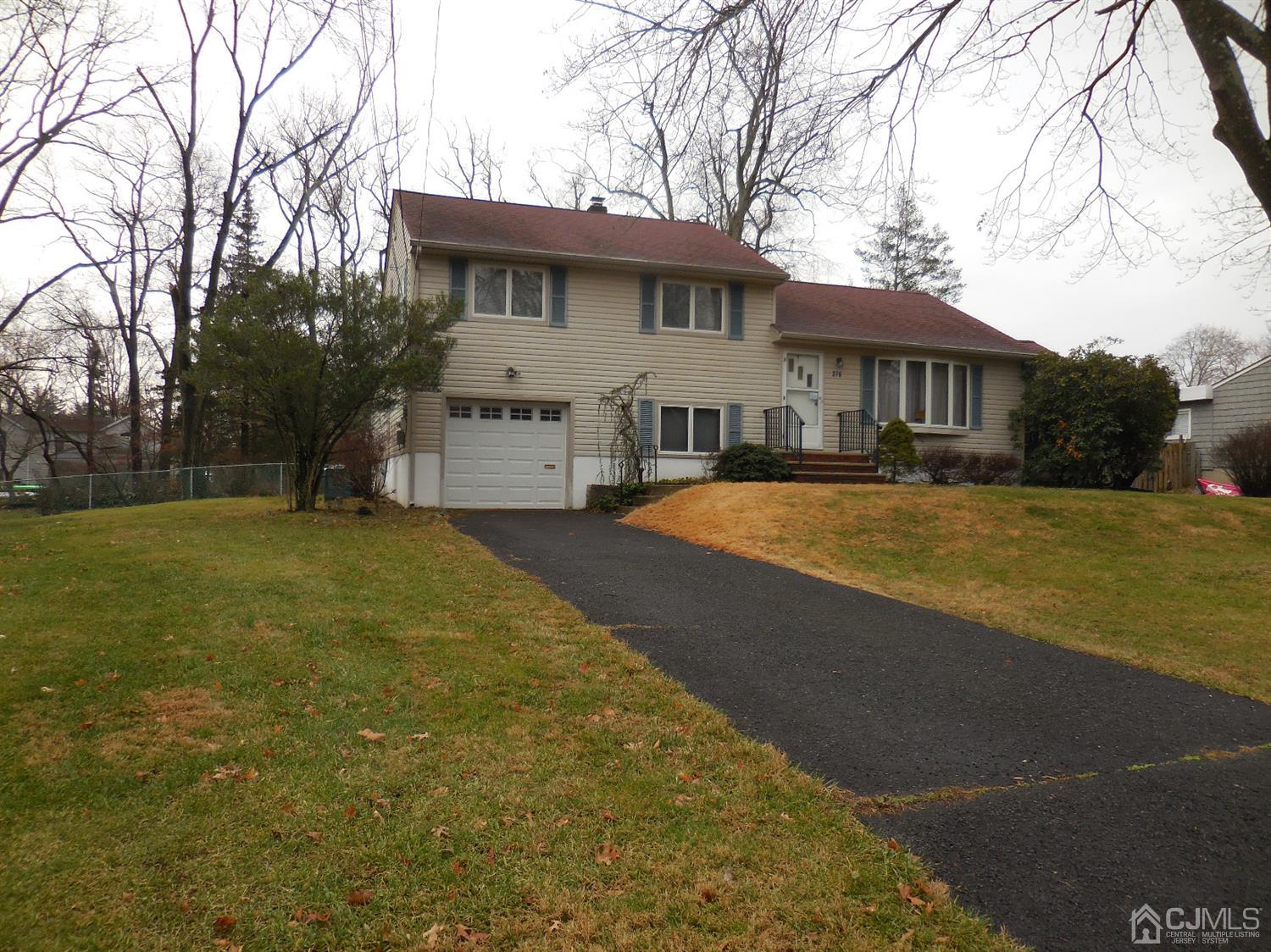 276 Carber Street Bound Brook, NJ 08805 - Photo 1 of 36 a view of a white house with a big yard and large trees