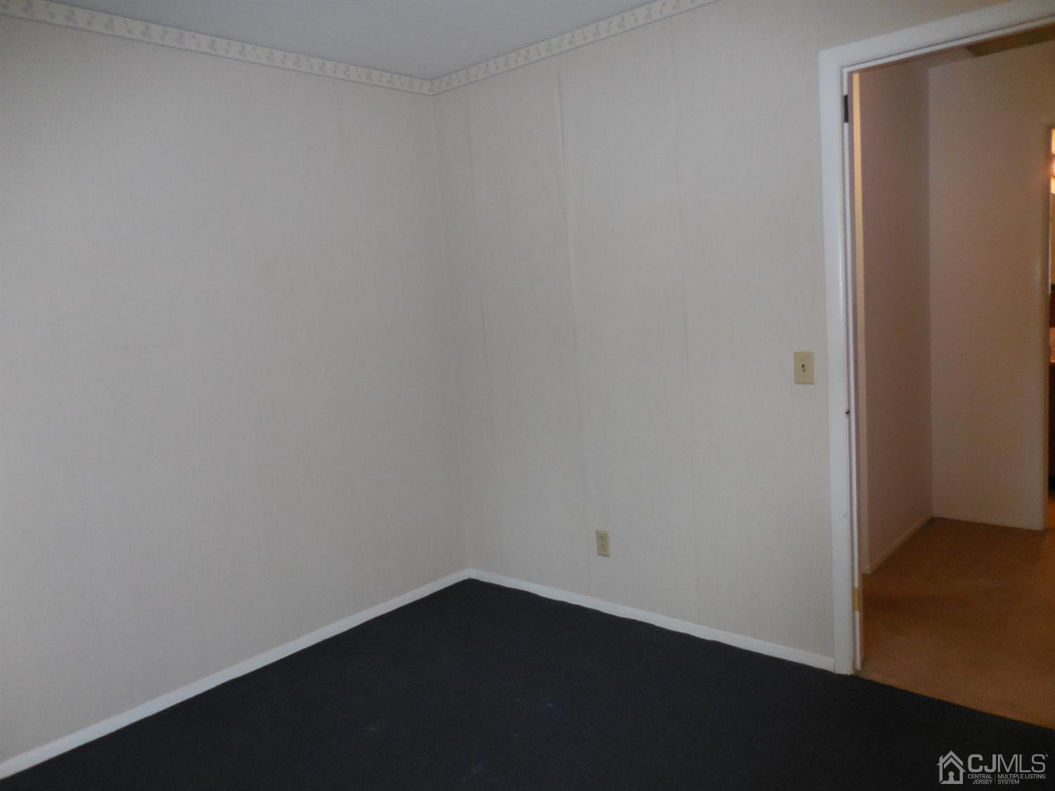 276 Carber Street Bound Brook, NJ 08805 - Photo 15 of 36 a view of an empty room with wooden floor