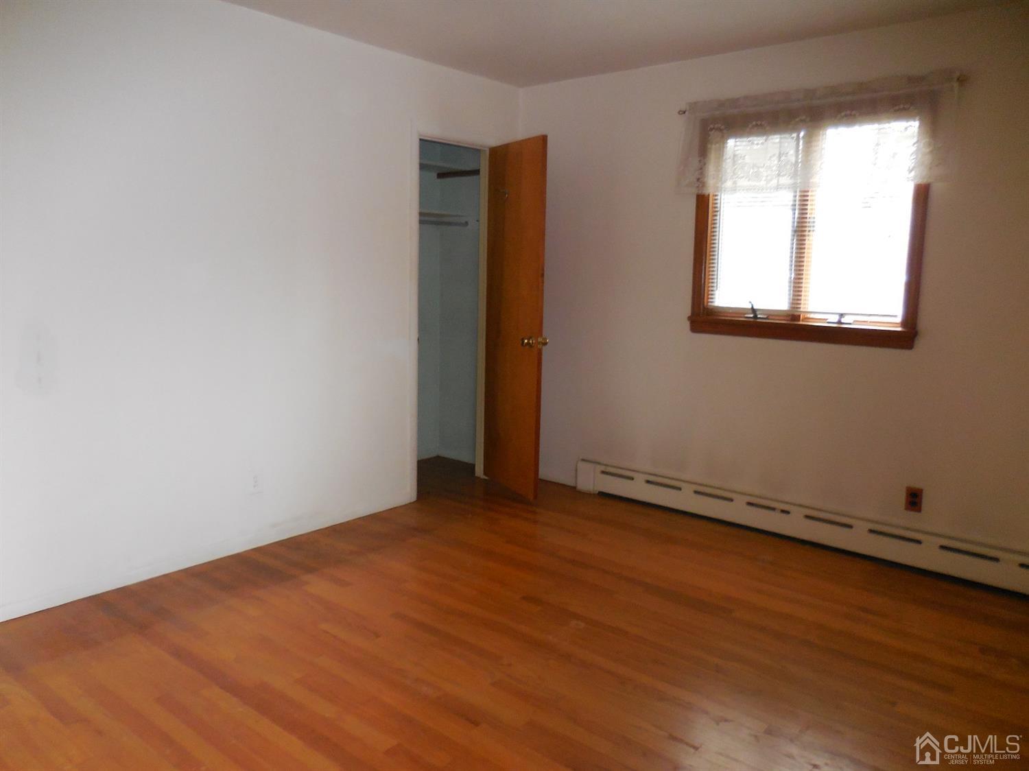 276 Carber Street Bound Brook, NJ 08805 - Photo 20 of 36 an empty room with wooden floor and windows