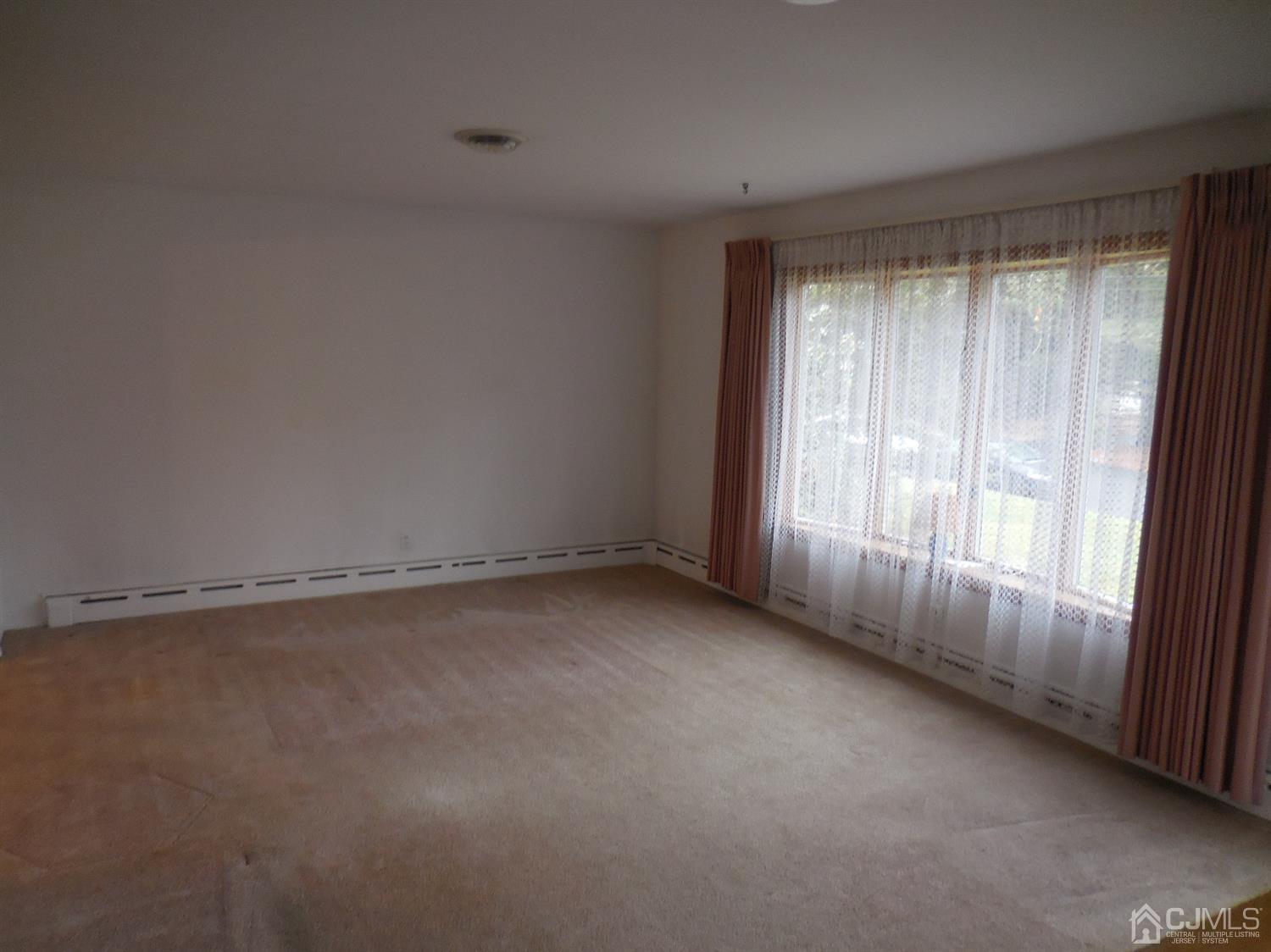 276 Carber Street Bound Brook, NJ 08805 - Photo 4 of 36 a view of an empty room with a window