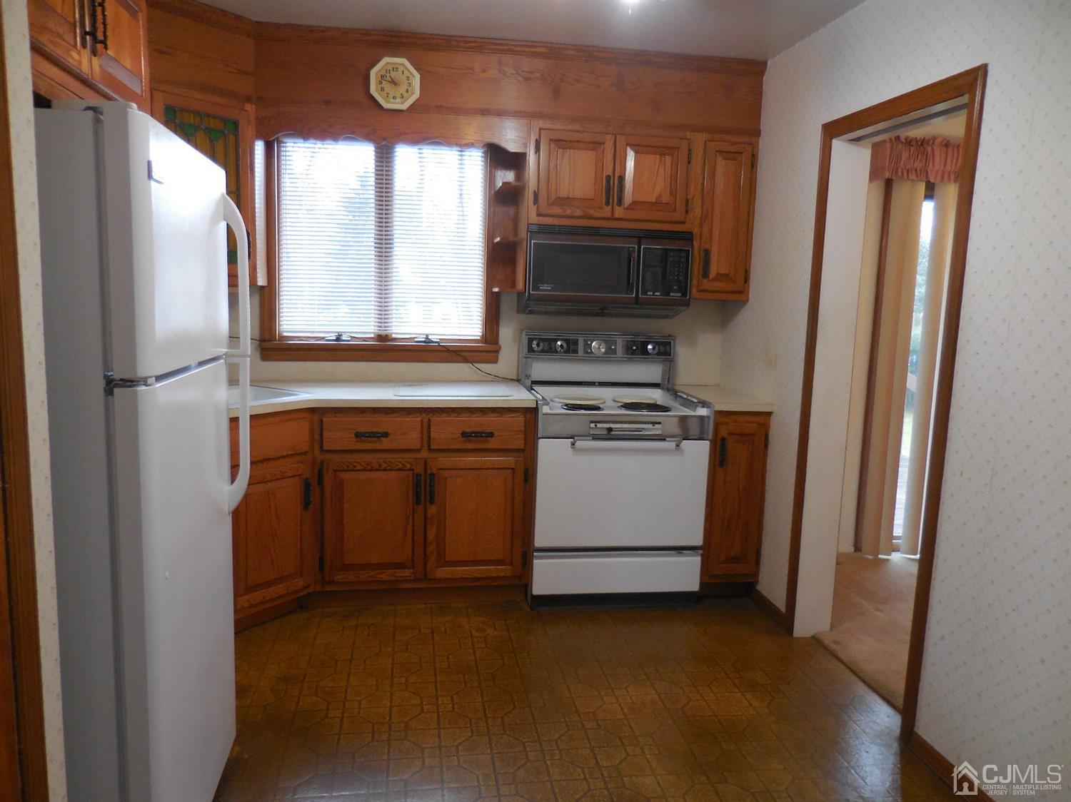 276 Carber Street Bound Brook, NJ 08805 - Photo 6 of 36 a kitchen with a stove and a refrigerator
