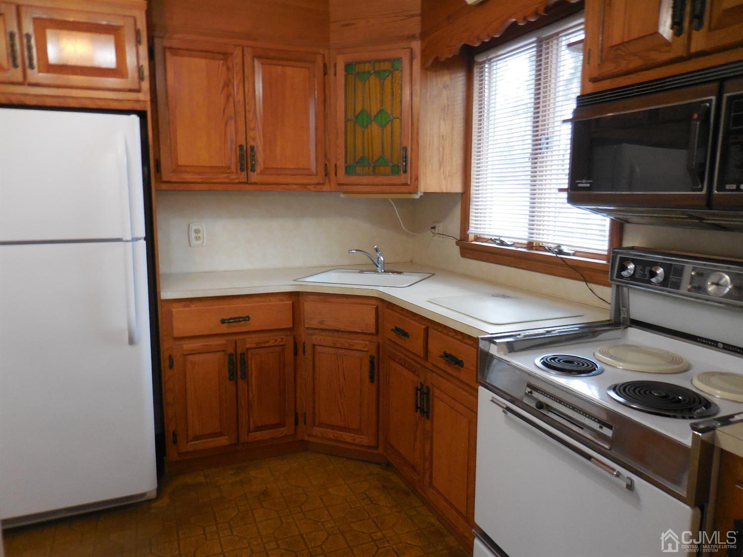 276 Carber Street Bound Brook, NJ 08805 - Photo 7 of 36 a kitchen with a stove microwave and refrigerator