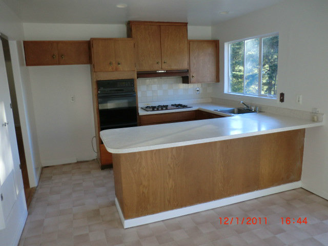 1247 Aspen Drive Pacifica, CA 94044 - Photo 10 of 12 a kitchen with a sink and wooden cabinets