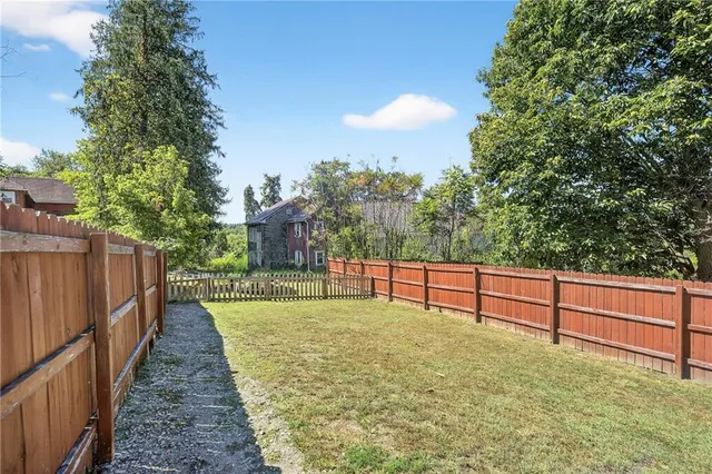 a view of balcony with wooden floor and fence