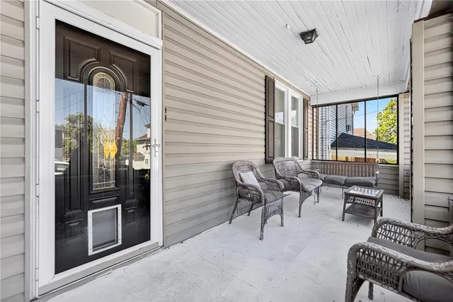 a living room with furniture and large windows