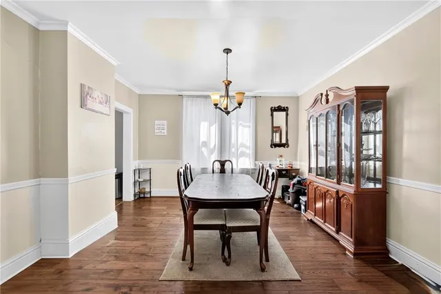 a view of a dining room with furniture wooden floor and chandelier