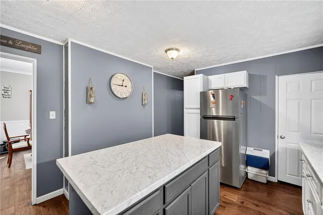 a kitchen with a sink a stove top oven and refrigerator