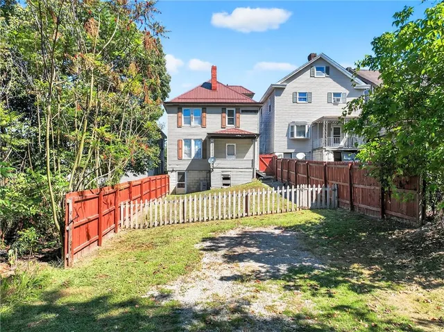 a front view of a house with a garden and deck