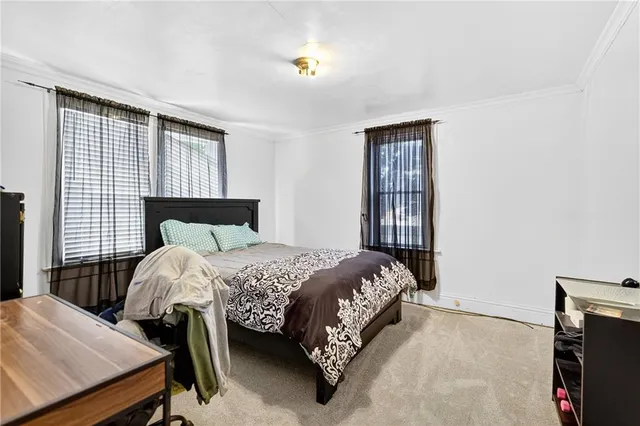 a bedroom with a bed and a lamp with window