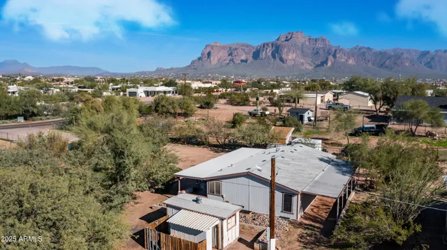 an aerial view of residential houses with outdoor space and trees