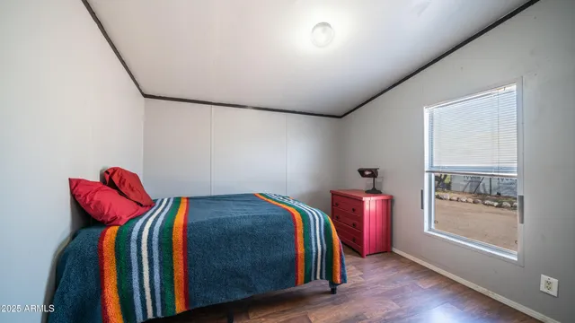 a front view of house with yard and trees in the background