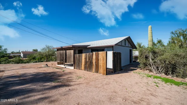 a view of kitchen with stainless steel appliances granite countertop a refrigerator and a stove top oven