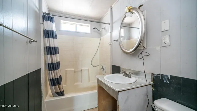 a view of a large white house with a large tree in front of it